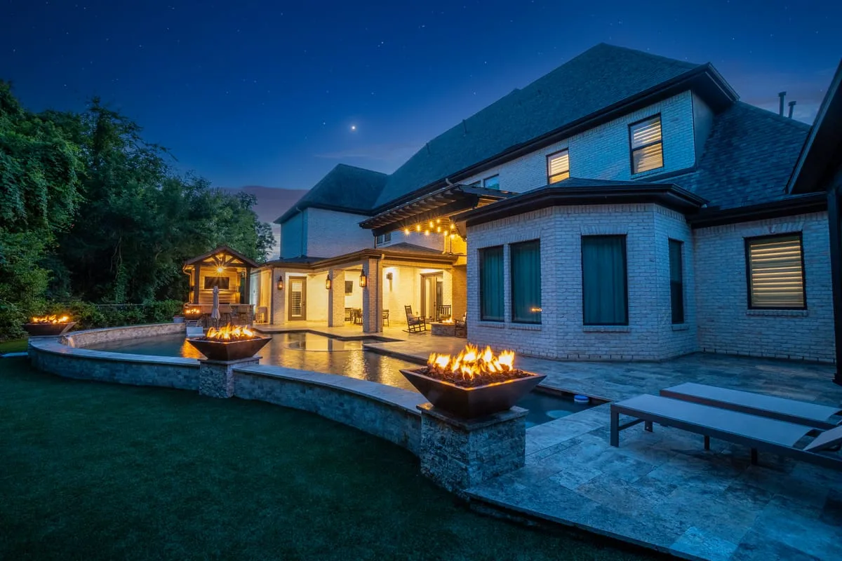 Backyard fire bowls on pool deck with travertine in Houston TX