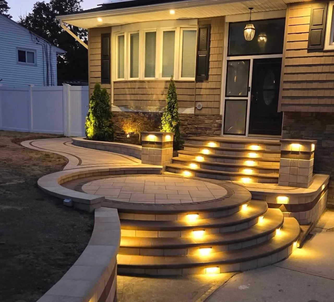 Custom stone steps with integrated LED lighting at night Houston TX
