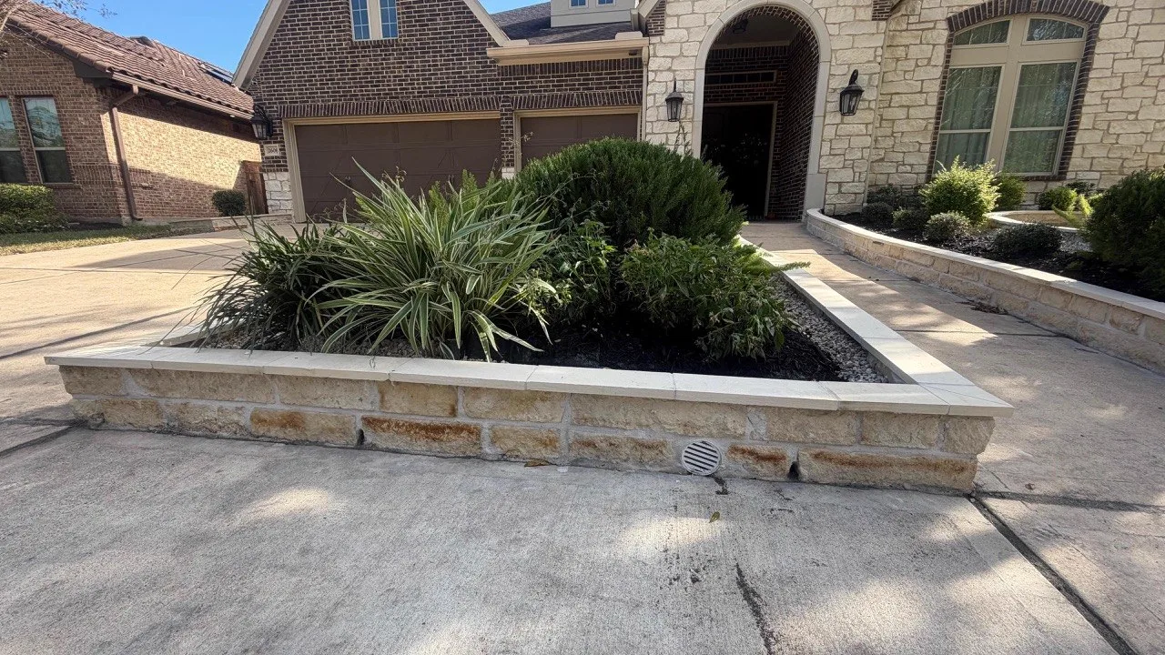 Natural stone landscape border with driveway entry in Houston TX