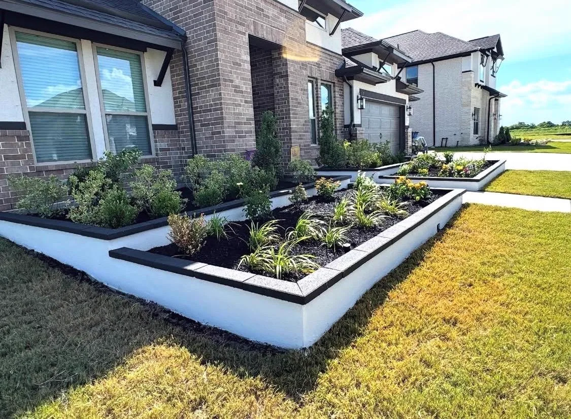 Modern concrete stone planters with black trim and front yard landscaping Houston TX