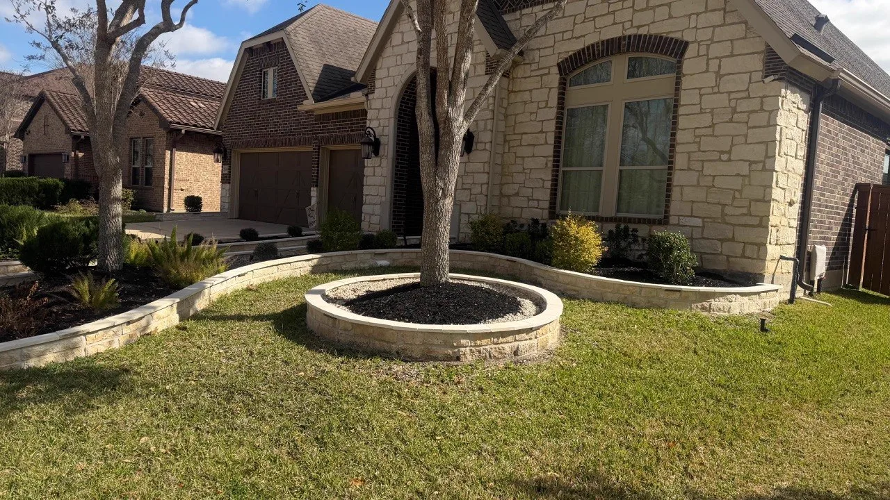 Circular stone tree ring and retaining wall in front yard Houston TX