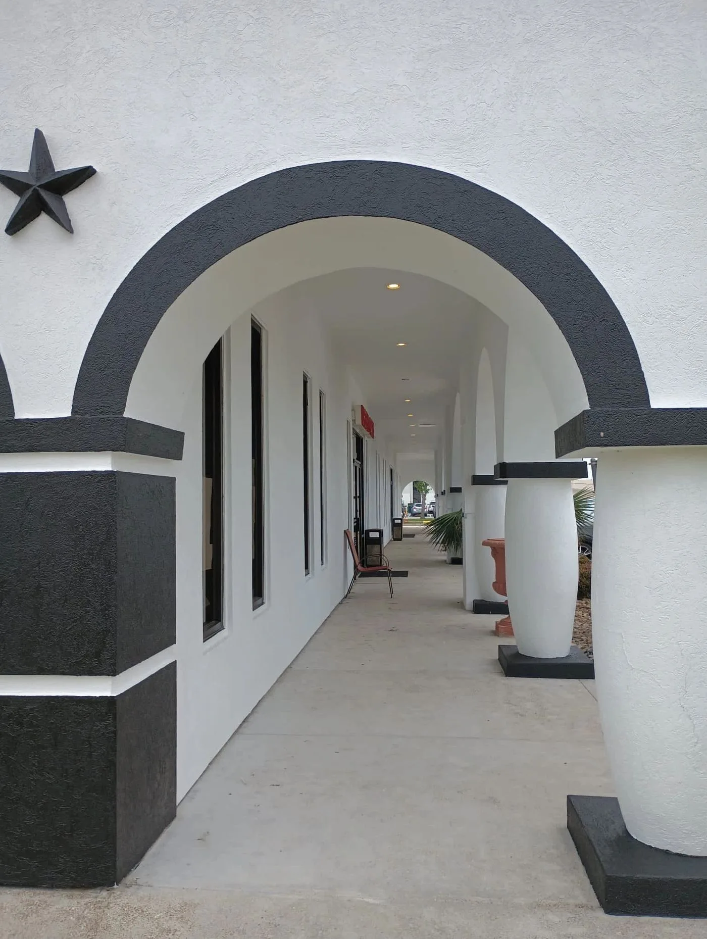Commercial building painting with decorative arches in Houston TX