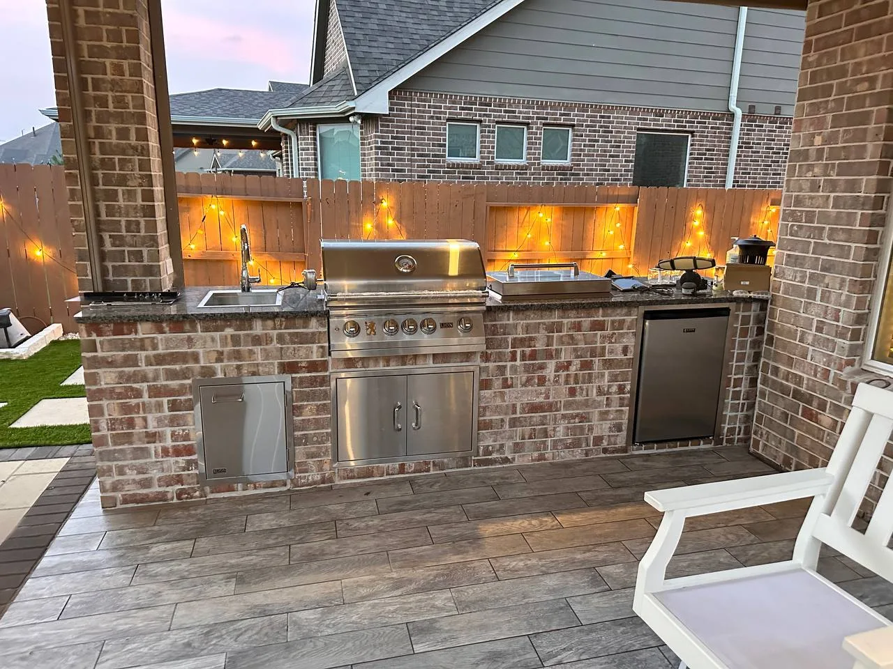 Luxury outdoor kitchen with seating bar and pergola in Houston TX