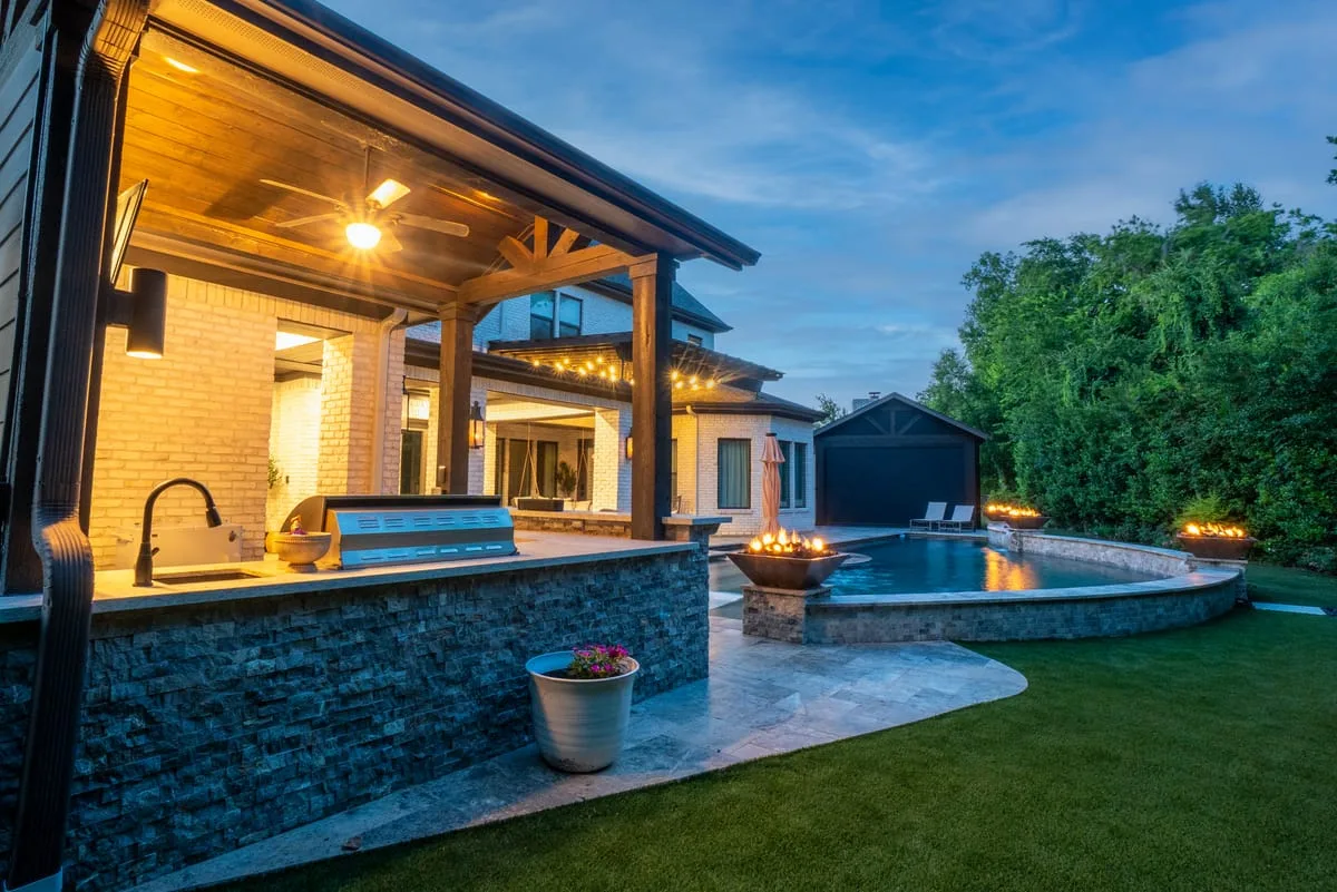 Outdoor kitchen with built-in grill under pergola in Houston TX