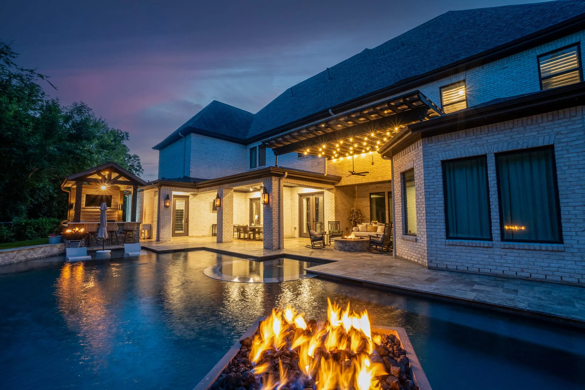 Luxury outdoor living space with pool and firepit in Houston TX