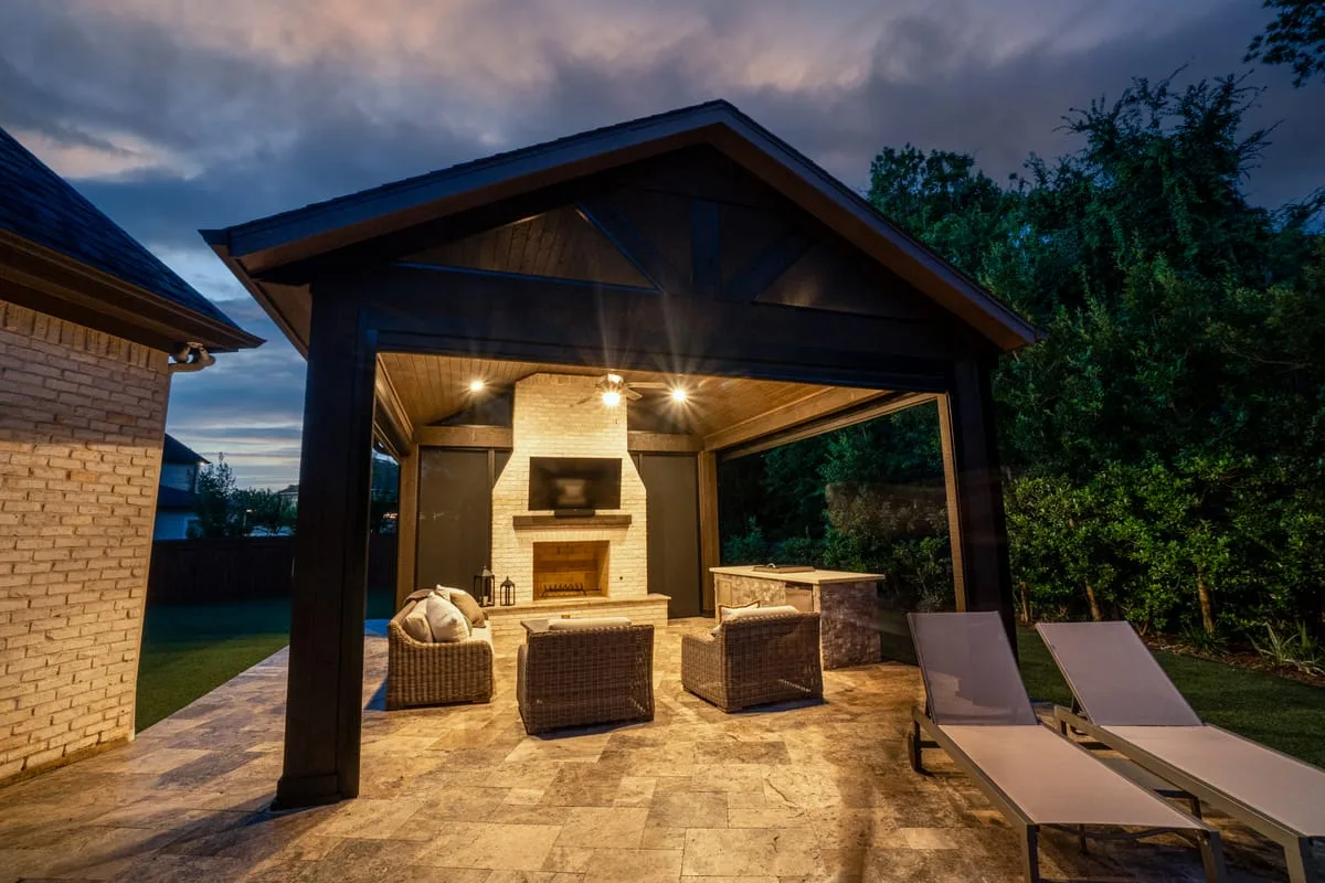 Outdoor living room with fireplace and pergola in Houston TX