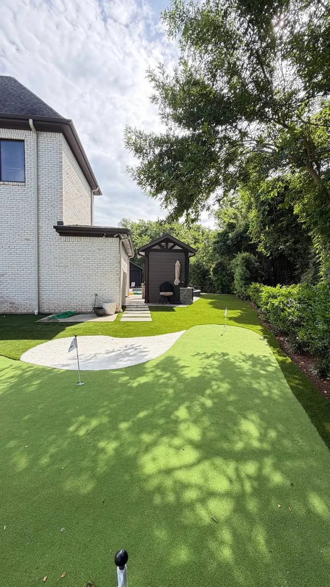 Outdoor living space with fireplace and string lights in Houston TX