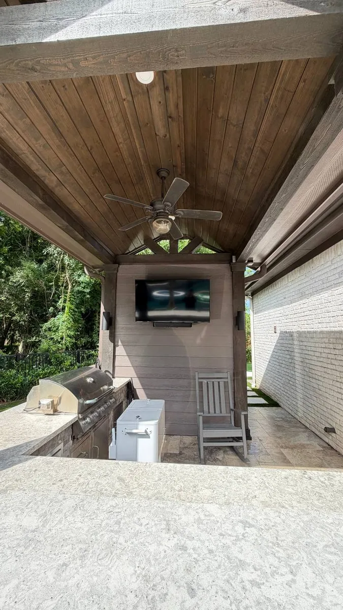 Complete outdoor living space with kitchen and dining area in Houston TX