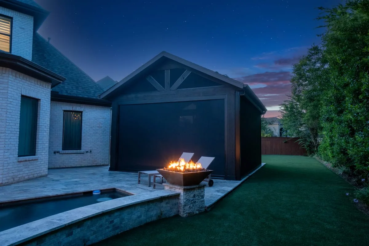 Pool house with fire bowl and artificial turf in Houston TX