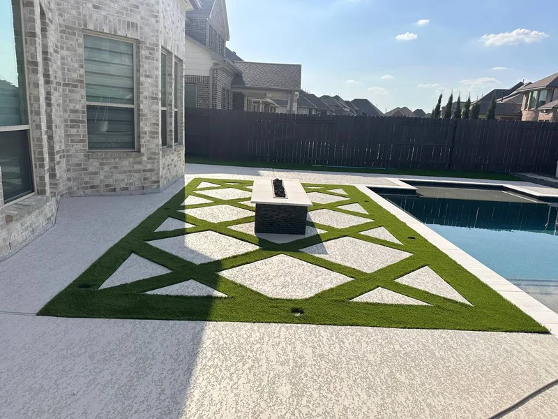 Geometric star pattern artificial turf cut into white concrete with fire pit table and pool in Cypress TX