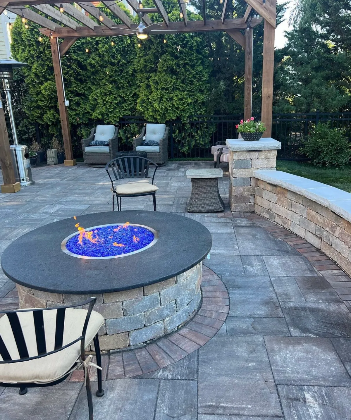 Outdoor fireplace with stone finish and patio seating in Houston TX