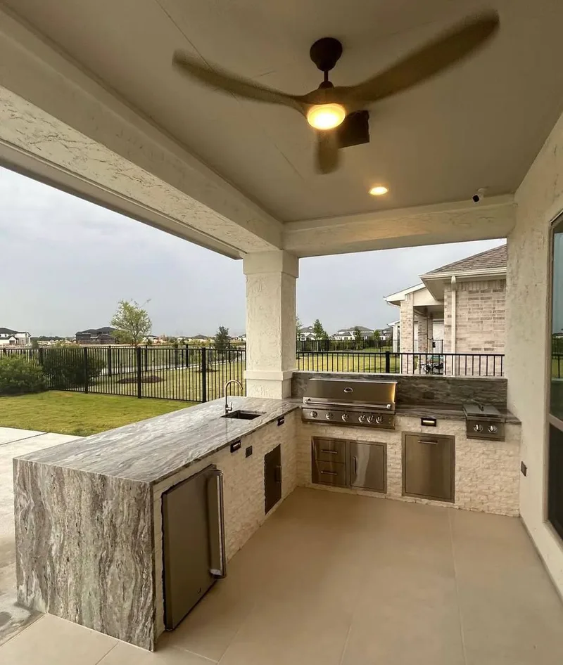 custom outdoor kitchen with grill and countertop build in Houston TX backyard