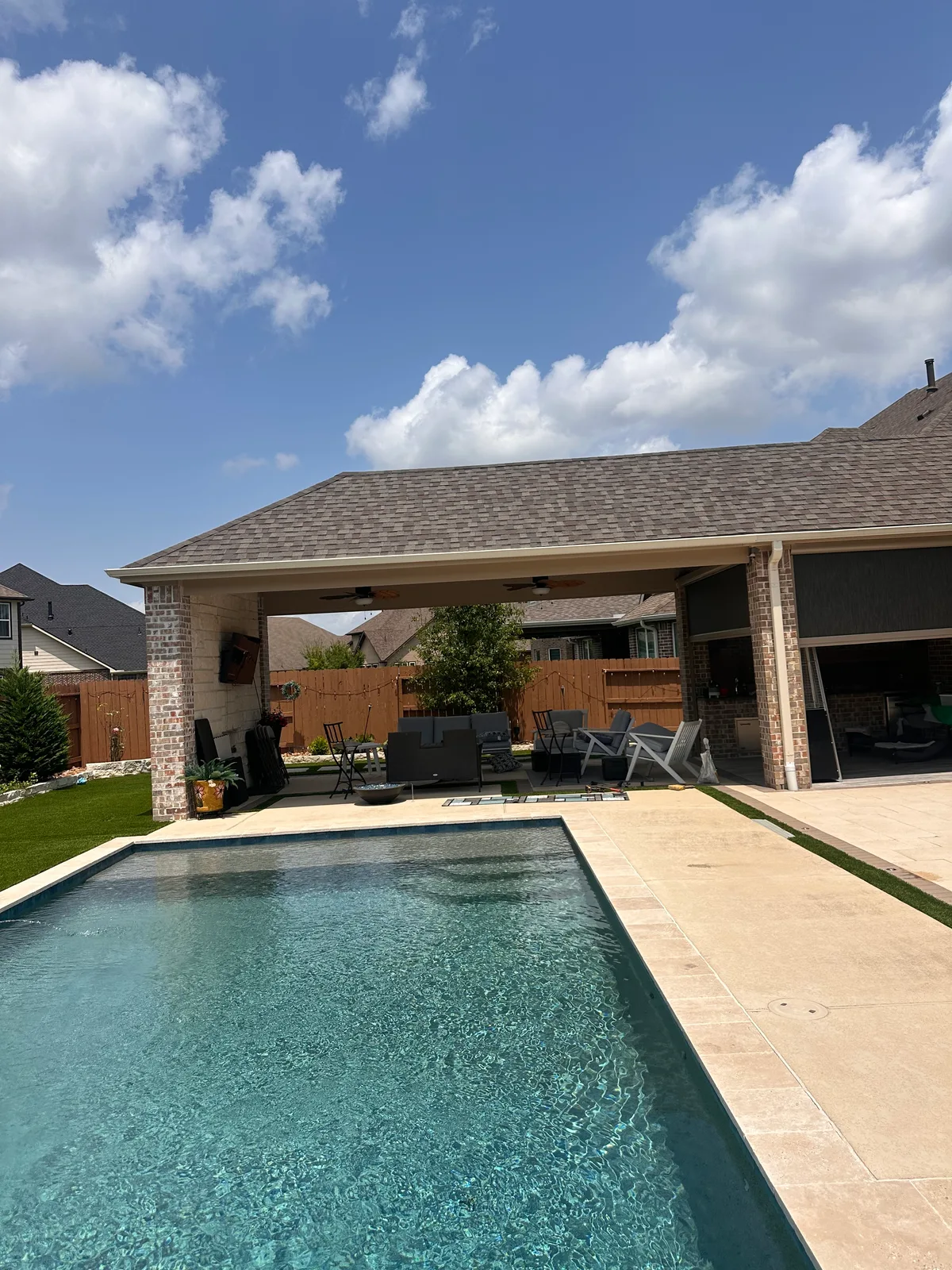 Attached patio cover with wood ceiling and recessed lighting in Houston TX