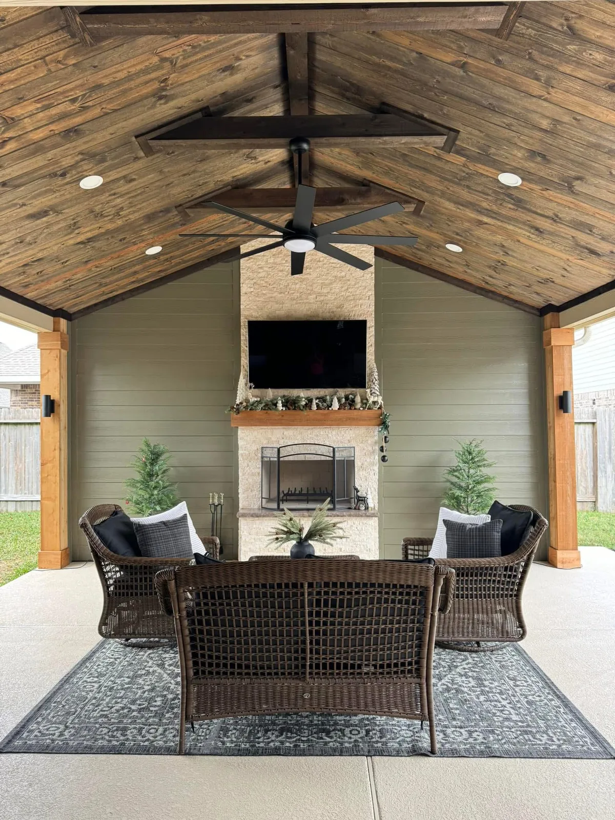 Patio cover with stone columns and ceiling fan in Houston TX