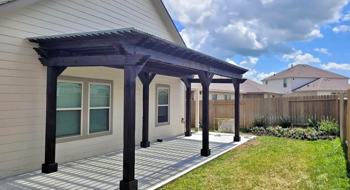 Custom pergola with seating area and shade structure in Houston TX