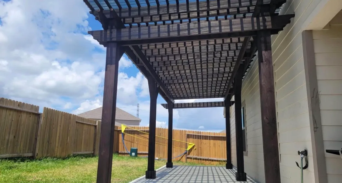 Outdoor pergola with integrated lighting and dining space in Houston TX